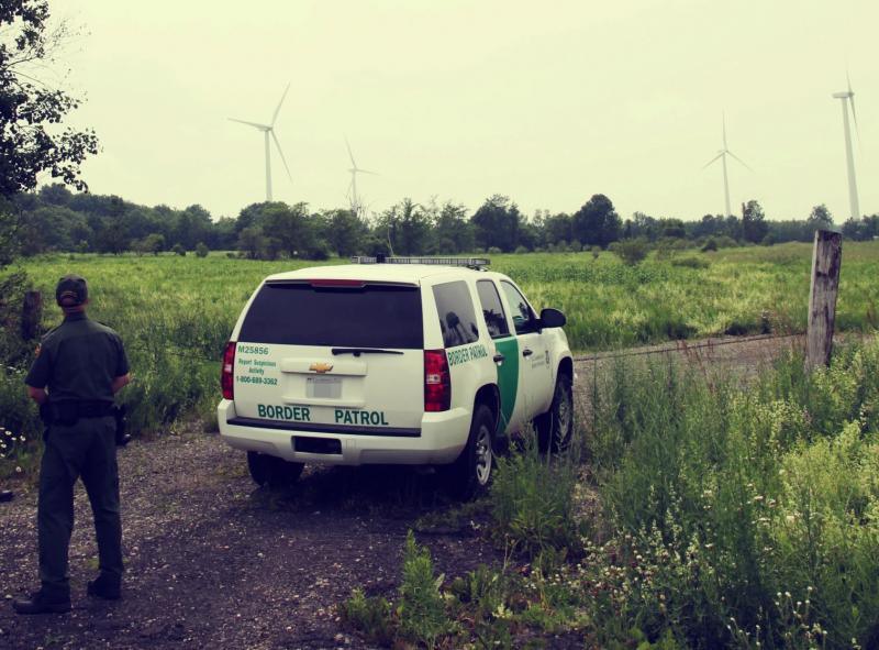 A U.S. Border Patrol agent surveys the international boundary with Canada.