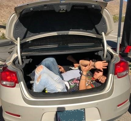 Three illegal aliens were found trapped in the back of vehicle in which a US citizen attempted to smuggle them into the United States.