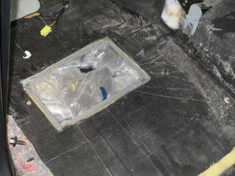 During the intensive examination at the San Ysidro port of entry, officers searched the vehicle and discovered 80 wrapped packages of narcotics in the vehicles floor - five pounds of heroin and 90 pounds of methamphetamine.