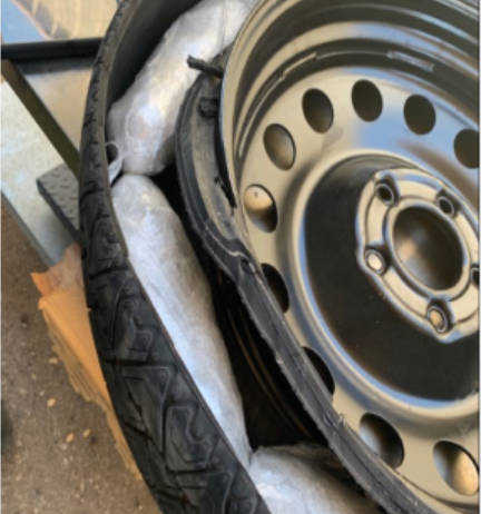 Border Patrol agents searched the trunk of the vehicle and discovered nine plastic wrapped bundles concealed inside of the spare tire that contained a white crystal like substance inside.  The substance tested positive for the characteristics of methamphetamine.