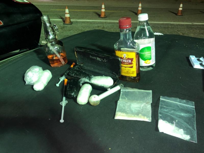 Agents searched the vehicle and discovered multiple small packages, two syringes filled with fluid and glass pipes hidden inside the vehicle.  