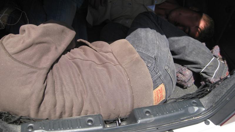 U.S. Border Patrol agents arrested a woman at the Interstate 8 checkpoint Tuesday for smuggling two Mexican nationals inside the trunk of her car.