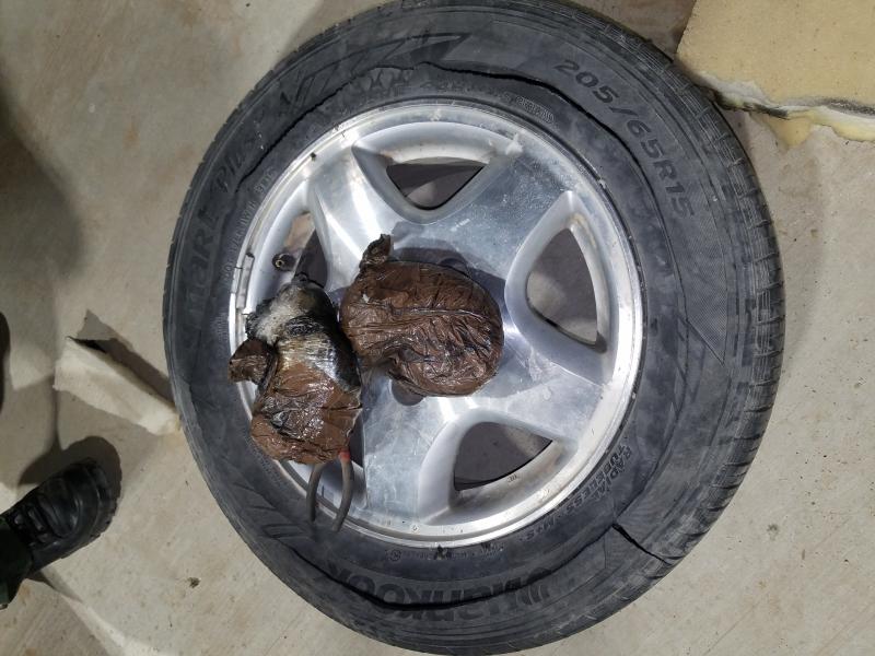 Border Patrol agents discovered two packages concealed inside the spare tire of the vehicle. Agents determined that the packages contained a substance that was consistent with the characteristics of methamphetamine.