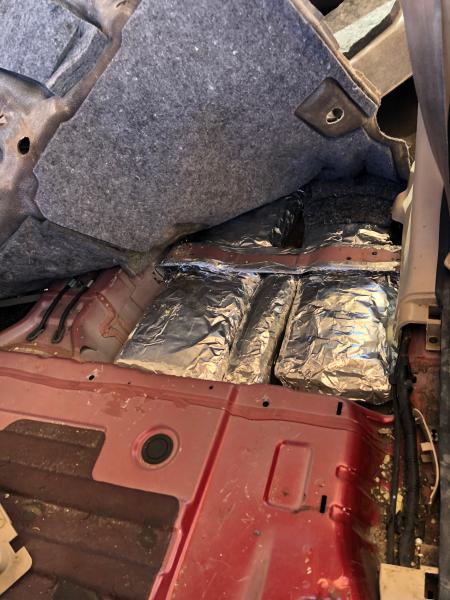 U.S. Border Patrol agents discovered 10 packages concealed inside the floorboard of the vehicle.