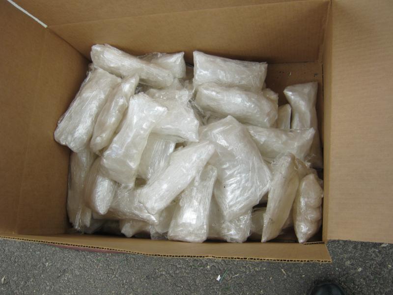 Agents discover 48 bundles of crystal methamphetamine in an aftermarket compartment above the gas tank.