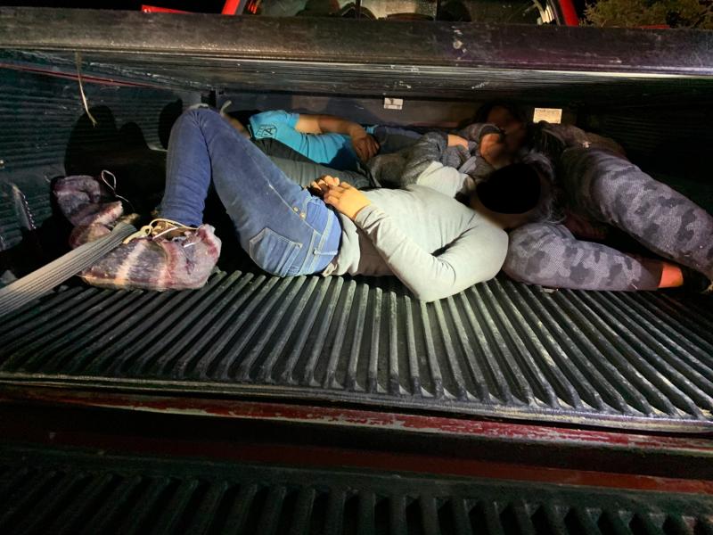 People hid themselves inside areas of a pickup truck.