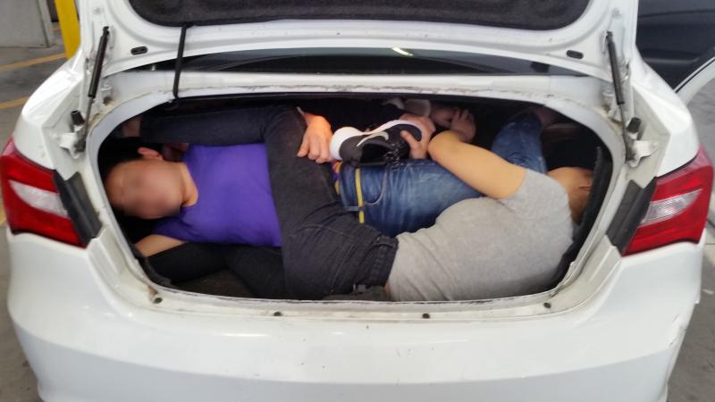 CBP officers find 4 Chinese nationals in car trunk.