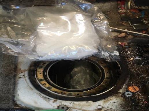 Agents discovered narcotics concealed in gas tank.