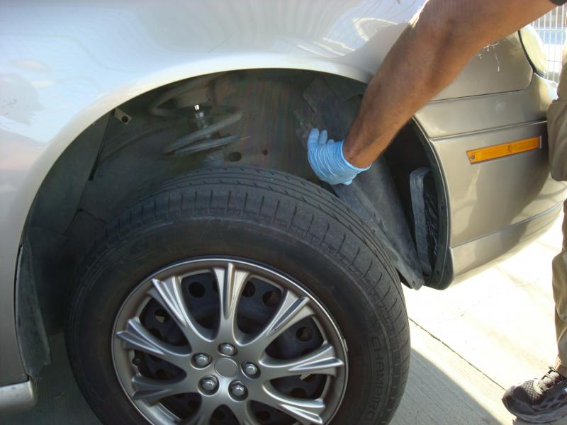 Bundles of cocaine were stashed in the front wheel wells of car. 