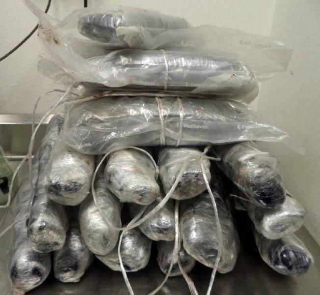 Officers at the DeConcini crossing in Nogales removed more than 20 packages of meth and heroin from within the rocker panels of a smuggling vehicle