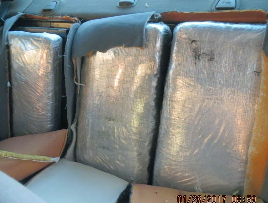 Officers seized more than 100 pounds of marijuana from within a smuggling vehicle