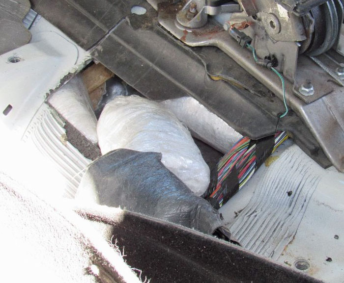 Officers discovered multiple packages of meth within the center hump of a smuggling vehicle