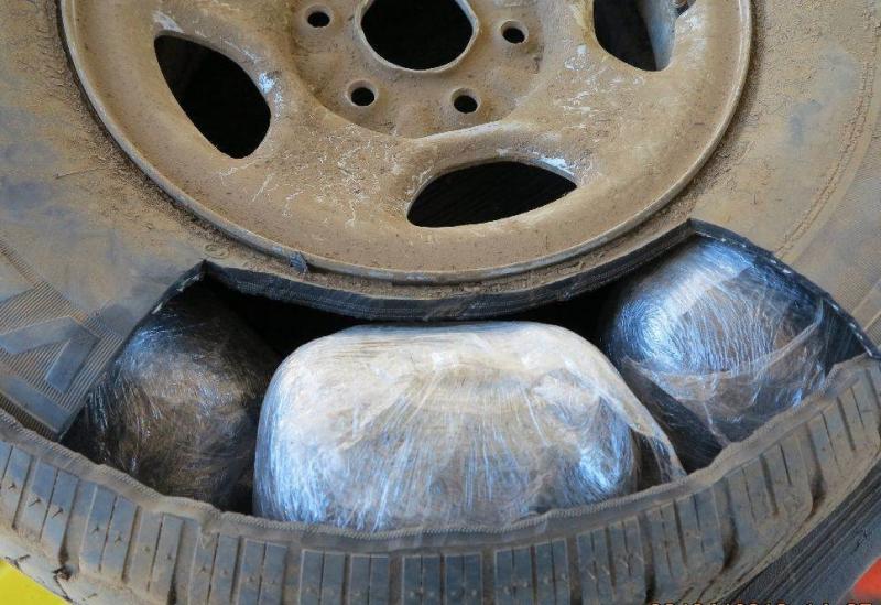 Officers discovered marijuana packages within the spare tire of a smuggling vehicle
