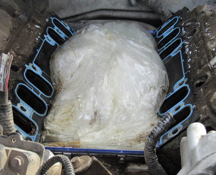 A drug smuggler attempted to hide five pounds of meth within the intake manifold