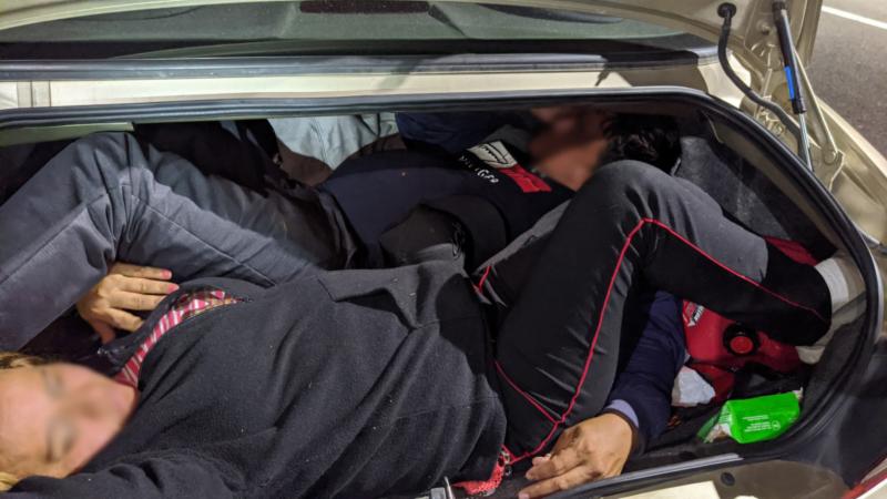 Agents discovered three individuals in the trunk of a smuggling vehicle