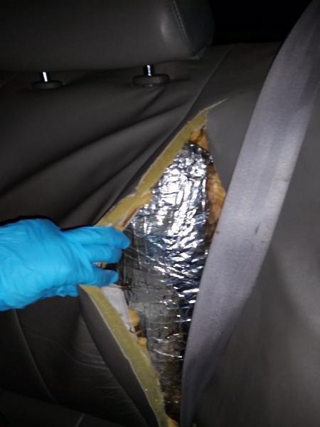 Officers discovered drugs within the back of the seats of a smuggling vehicle