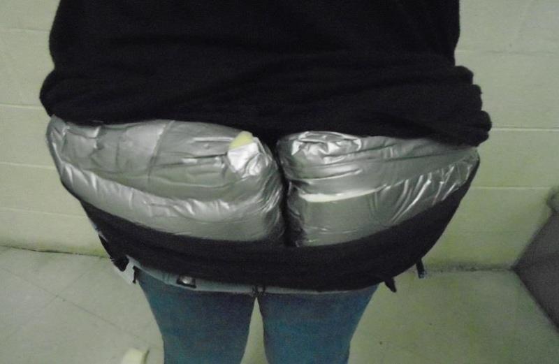 Officers seized close to 3 pounds of heroin, which a body carrier had attempted to hide inside the back of her pants.