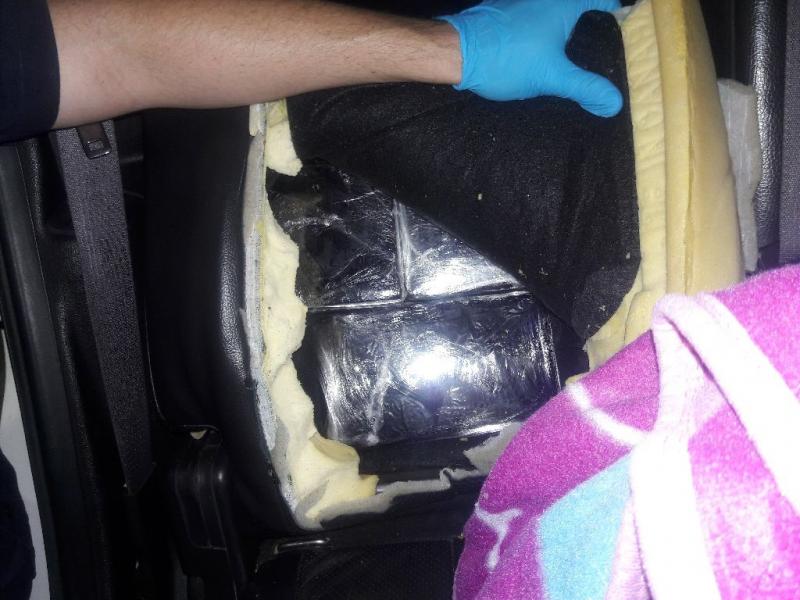 Officers located more than 34 pounds of cocaine within the backseats of a smuggling vehicle