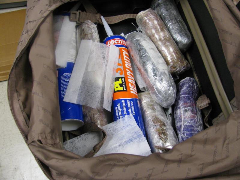 Agents discovered more than 20 pounds of heroin that had been stuffed into tubes of caulking material