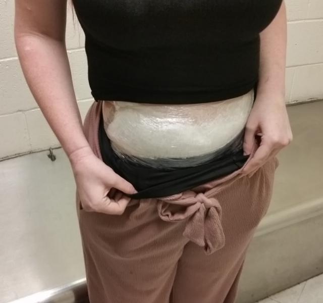 Officers arrested the woman who had drugs strapped to her body