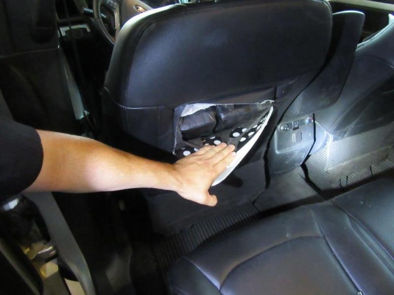 Officers in Nogales discovered packages of unreported currency within the seat back of the driver's seat 