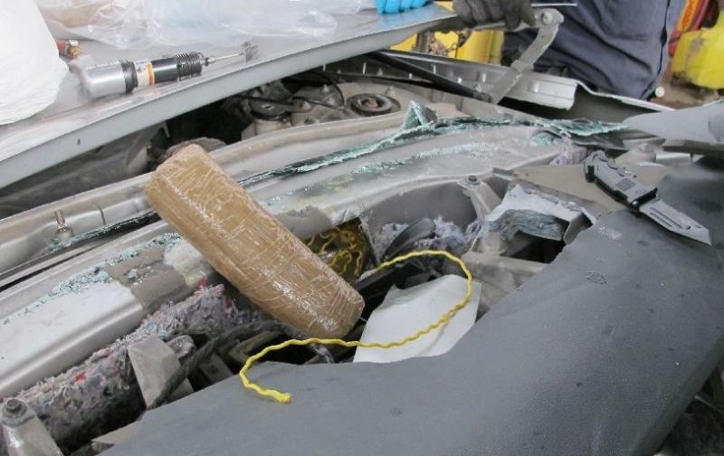 Officers removed a combination of meth and cocaine from the firewall of a smuggling vehicle