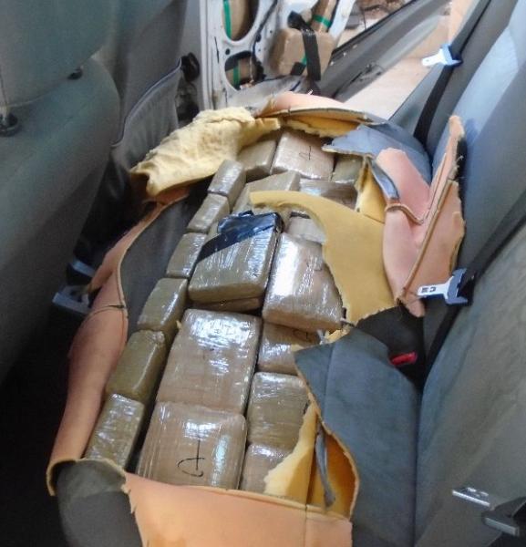 The bench seats of a smuggling vehicle are found to contain packages of marijuana, by CBP officers at the Port of Douglas.