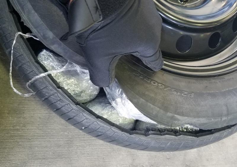 Officers discovered 18 pounds of meth inside of the spare tire of a smuggling vehicle at the DeConcini Crossing.