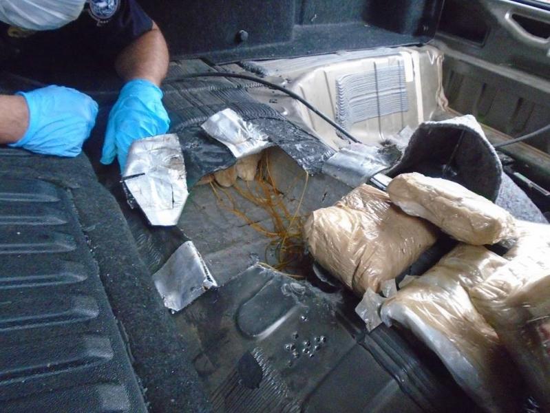 Officers discovered packages of hard drugs within the trunk of a smuggling vehicle