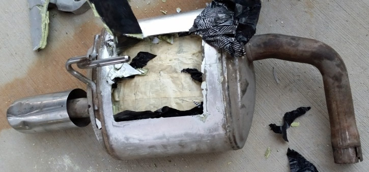 the muffler of a smuggling vehicle was removed and opened to reveal nearly 10 pounds of meth