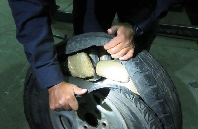Officers were led to the spare tire of a smuggling vehicle, where they found heroin and cocaine