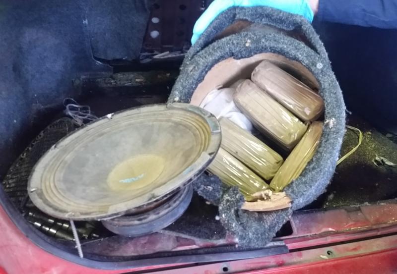 Officers uncovered 38 pounds of cocaine in the back seat and speaker box of a smuggling vehicle