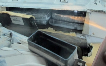 Officers removed packages of cocaine that were hidden within the firewall of a smuggling vehicle
