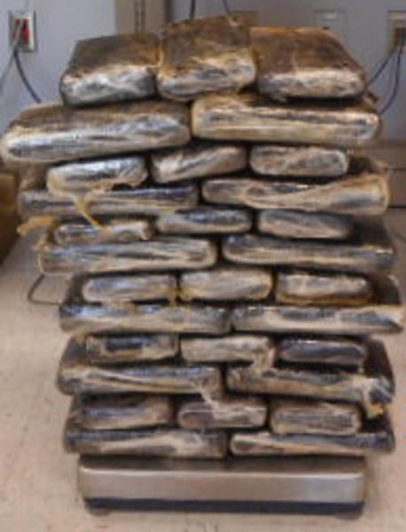Officers discovered 58 packages of alleged marijuana within the truck bed area of the vehicle.