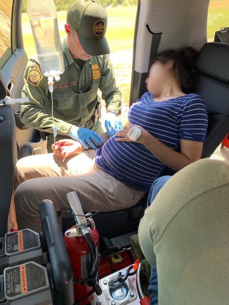 A Presidio Border Patrol Station agent provides emergency medical treatment to a pregnant woman in distress.