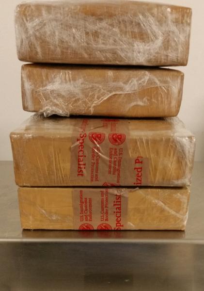 CBP officers retrieved four packages of brown heroin concealed within the battery of the vehicle.