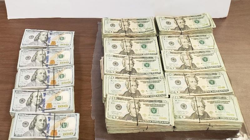 Stacks of bills totaling $99,118 in unreported currency seized by CBP officers at Brownsville Port of Entry.
