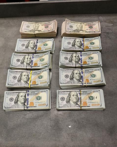 Stacks containing $100,350 in undeclared currency seized by CBP officers at Brownsville Port of Entry