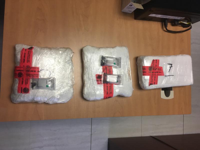 Packages containing five pounds of heroin, two and ahalf pounds of cocaine seized by CBP officers from a body carrier at Laredo Port of Entry