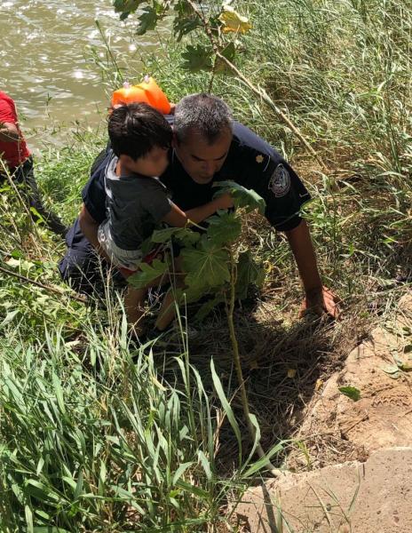 A CBP officer assist in the rescue of a child that had been pinned in strong current in the Rio Grande near Brownsville's Gateway International Bridge