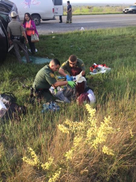 Laredo Sector Border Patrol agents render first aid to two rollover accident victims