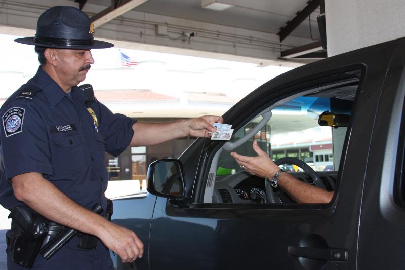 A CBP officer conducts a primary inspection