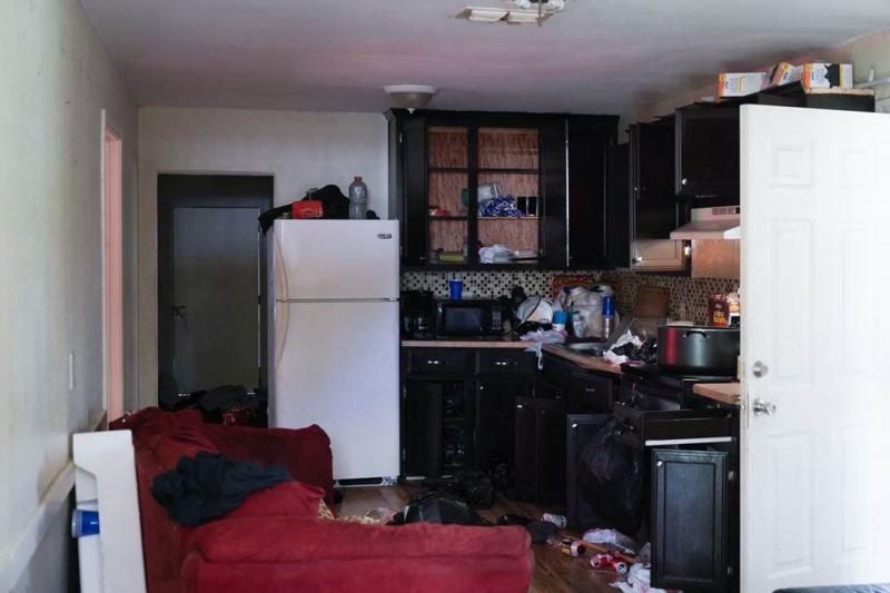 Items are strewn about within a stash house in which 82 migrants were discovered