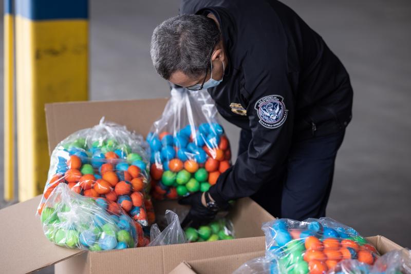 A CBP agriculture specialist examines bags of cascarones at Laredo Port of Entry