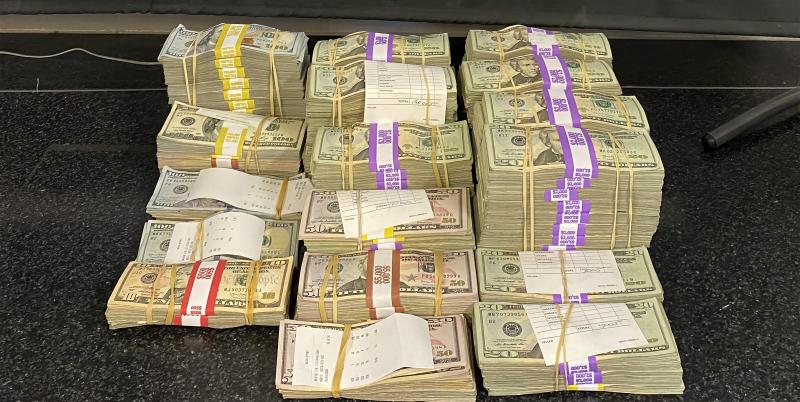 Stacks containing $297,311 in unreported currency seized by CBP officers at Del Rio Port of Entry