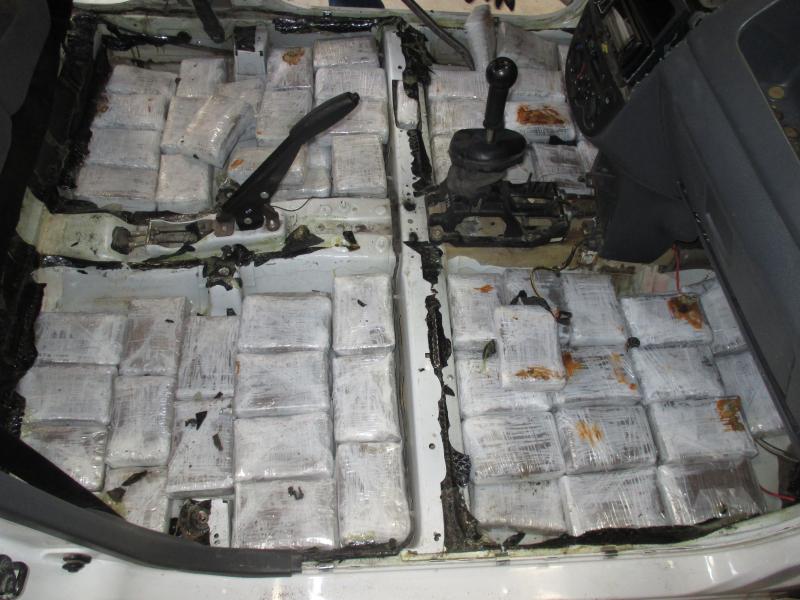 Drug bundles in floor of vehicle.