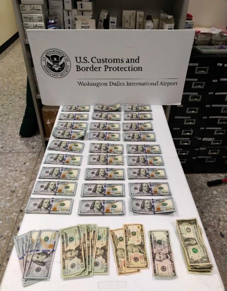 CBP officers display nearly $28,000 in unreported, seized currency at Washington Dulles International Airport May 30, 2019.