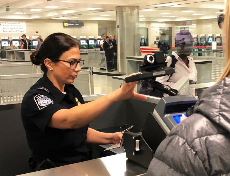 CBP officer using facial recognition technology at Washington Dulles International Airport recently.