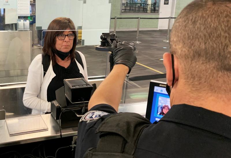 A traveler processes her admission using CBP's enhanced biometric facial comparison process at Philadelphia International Airport recently..