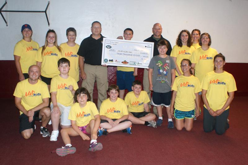 U.S. Border Patrol agents present a $3,000 donation to MVP Kids in Plattsburgh, N.Y., on July 28, 2016.